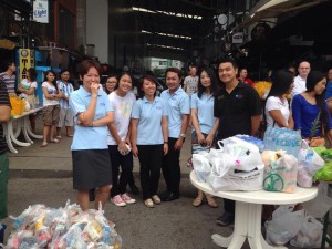 Staff from PLS offer alms for Asarnha Bucha Day