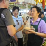 Students buy fruit at the market